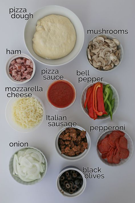 Make pizza night super duper out of this world with this Homemade Supreme Pizza recipe featuring a hearty combination of vegetables and meat. This recipe is a great DIY alternative to the pizzeria classic that you can customize supreme pizza toppings to your personal preferences -- without paying extra! Supreme Pizza Toppings, Pizza Diy Homemade, Pizza Topping Ideas Homemade, Make Ur Own Pizza, Home Made Pizza Night, Homemade Pizza Ingredients List, Pizza Ingredients List Recipe, Goofy Movie Pizza Recipe, How To Make Homemade Pizza