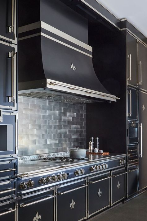 All-black kitchen with chrome detailing. The entire stove, range, and surrounding cabinets are in black stainless steel, with a black tile backsplash Dark Kitchen Ideas, Paris Dark, Paris Kitchen, New Status, Luxury Appliances, Kitchen Appliances Luxury, High End Kitchens, Kitchen Time, Dark Kitchen