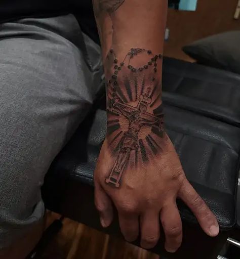 15 Exceptional Jesus Tattoo Designs and Ideas 2023 Rosary Hand Tattoo Men, Angle Arm Tattoo, Christian Hand Tattoos For Men, Jesus Related Tattoos, Cross Hand Tattoo Men, Cross Sleeve Tattoo Men, Jesus Tattoo Design For Men, Rosary Tattoo For Men, Rosary Hand Tattoo