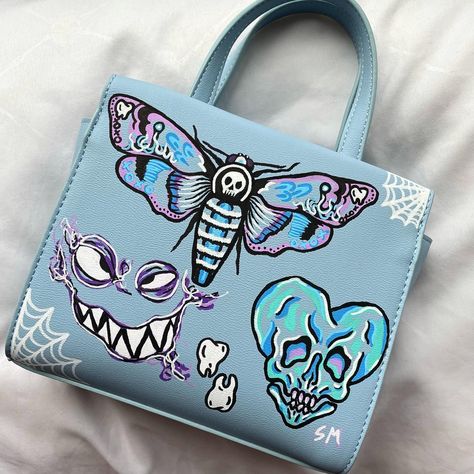 This is a one-of-a-kind, custom purse drawn on by me with posca paint pens! #art #artist #fashion #diy #artwork #spooky #creative #egirl #alt #skull #moth #drawing #painting Custom Bags Painting, Painted Purses Ideas Diy, Custom Purses Paint, Painted Bag Ideas, Painting Purses Diy, Posca Clothes, Alt Purse, Drawings On Bags, Purse Painting Ideas