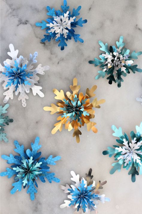 handmade 3D snowflakes in gold, silver, teal and blue foiled paper Snowflake Svg Free Cricut, Snowflake Cricut, Paper Snowflake Template, 3d Paper Snowflakes, Aesthetic Paper, How To Make Snowflakes, 3d Snowflakes, Snowflake Template, Paper 3d