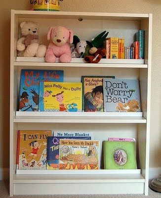 We made this children's book rack by adding a bar on each shelf, so that the books can be displayed facing front. This is an inexpensive Billy bookshelf from Ikea ($40). And the bars are mouldings purchased from Lowes (about $5 total).  I could display dishes like this too! Bookshelf Ikea, Front Facing Bookshelf, Ikea Book, Billy Ikea, Ikea Billy Bookcase Hack, Montessori Room, Ikea Bookshelves, Ikea Billy Bookcase, Ikea Billy