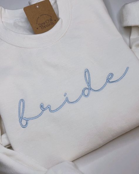 Bride Embroidered Crewneck Sweatshirt 👰‍♀️🩵🦋✨ Looking for the perfect bridal shower gift? Snag one of these cozy crews for the Bride To Be! ✨ Now available to shop online! ▶️▶️ Customization available to add on sleeve embroidery with a wedding date or initials! - #embroidery #shoplocal #hollister #daydream #country #western #smallbusiness #diy #sanbenitocounty #embroiderersofinstagram #cowgirl #rodeo #rodeofashion #westernstyle #westernfashion #embroiderybusiness #bridalshower #bride #... Embroidered Shirt Ideas, Initials Embroidery, Pearl Stitch, Perfect Bridal Shower Gift, Bride Sweatshirt, Sleeve Embroidery, Cowgirl Rodeo, Rodeo Fashion, Embroidered Crewneck