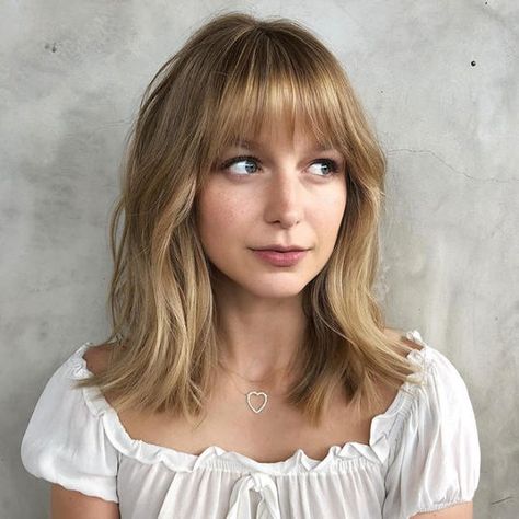 We're firm believers that every woman should try bangs once in her life. For oval faces, bangs are extra flattering. #southernliving #hairstyles #ovalface Cute Modern Haircuts, Wispy Textured Bangs, Thick Bangs Round Face, Medium Hair With Bangs And Glasses, Medium Length Bangs Fringes, Long Bob Bangs Round Face, Short Hair With Fringe Bangs Round Faces, Eyebrow Length Bangs, Medium Length Haircut With Fringe