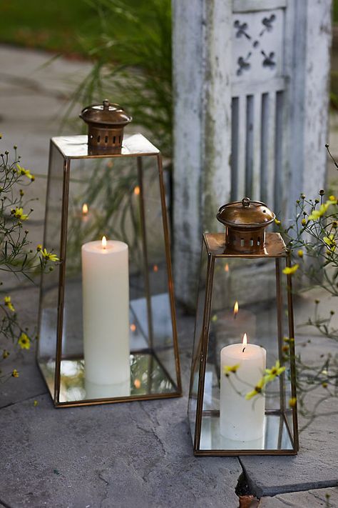 Defined by its pyramid silhouette and brass finish, this classic lantern is the perfect place to display candles or strands of lights. Animation Environment, Lantern Pathway, Glowing Forest, Iron Lanterns, Swinging Doors, Candle Displays, Brass Lantern, Pathway Lighting, Solar Lanterns