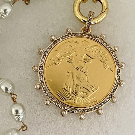 Gold French Coin Pendant This is a gorgeous high luster, white porcelain pearl, French Commemorative coin Necklace. The porcelain glass, replica potato shaped freshwater pearls are strung together with gold wire making this a stunning piece of jewelry. The reproduction coin pendant, a French Commemorative medal coin is surrounded by Cubic Zirconia stones and pearls. It elegantly hangs from a gold, spring lock clasp with CZ accents. The bale attached to the coin is also encrusted with CZ stones. A stunning Art Deco/Antique-inspired piece of jewelry Perfect for a gift or just for yourself:) Approximate size of coin and bezel - 50mm Approximate size of Pearls- 10mm x 8mm These statement pieces combine fashion and functionality, offering a trendy edge to your ensemble. Discover the perfect fus Gold Coin Jewelry, French Coins, Commemorative Coins, Antique Inspiration, Gold Coin, Gold Wire, Coin Necklace, Keep Jewelry, Coin Pendant