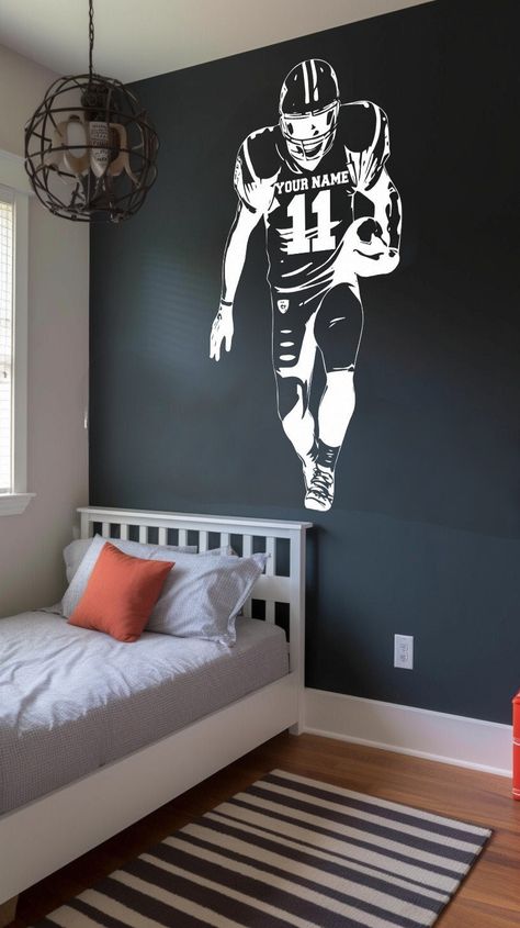 Transform your space with this Custom Football Player Wall Decal. Whether you're a die-hard football fan or simply love the sport, this wall decal offers a unique and personalized touch to your decor. Customize it with the name and numbers of your favorite player, creating a one-of-a-kind piece that truly showcases your passion. Crafted from high-quality vinyl, this durable sticker features a striking player jerseys design. It's the perfect addition to sports-themed spaces, bedrooms, game rooms, Football Game Room, Football Room Ideas For Boys, Teen Boys Sports Bedroom Ideas, Nfl Bedroom Ideas, Diy Football Room Decor, Sports Room For Boys, Boy Football Bedroom, Teen Boy Sports Bedroom, Boys Sports Room Ideas