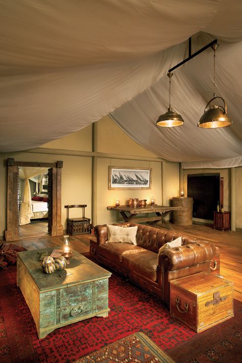 "The two-year-old Zarafa Camp is already one of the finest camps in Botswana, but the property's two suites, which are less than a 10-minute drive away, are a cut above. The Dhow Suites are actually one huge tent, with a living room and two large bedrooms, furnished with leather sofas, Persian carpets, and copper bathtubs, all meant to evoke the 1920s luxury safari. What's outside is just as magical: the Zibadianja Lagoon, Living Room Camping, Lodge Interiors, Best Hotels In The World, Tent City, Tent Room, Glamping Ideas, Royal Lodge, Safari Camp, Lodge Design