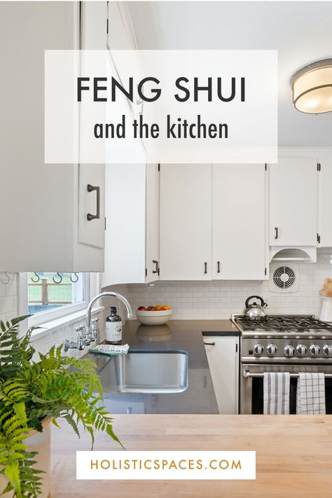 Photo of white kitchen with stainless steel oven and green plant on the counter. Text: "Feng shui and the kitchen. Holisticspaces.com" Holistic Kitchen Design, Kitchen Feng Shui Layout, Feng Shui Kitchen Layout, Feng Shui Layout, Corner Kitchen Table, Decorating Above Kitchen Cabinets Ideas, Feng Shui Kitchen, Grey Blue Kitchen, Decorating Above Kitchen Cabinets