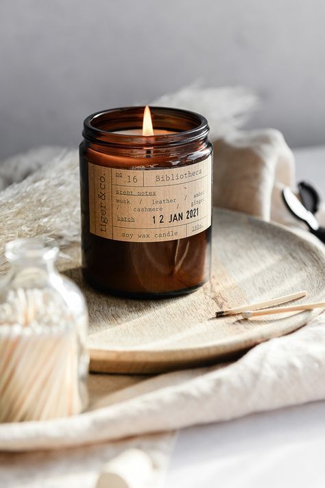 Illuminate Candle, Amber Candles, Burning Paper, Candle Photography Ideas, Candle Photoshoot, Apothecary Style, Amber Jar Candle, Amber Candle, Wooden Floorboards