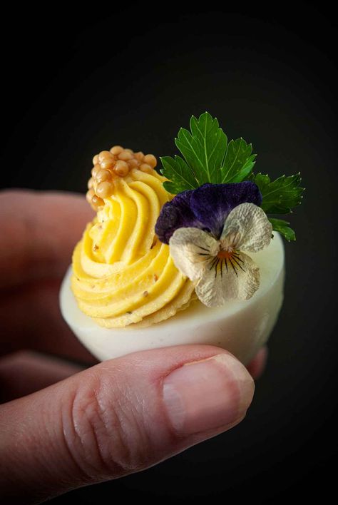 These beautiful deviled eggs are absolutely perfect for any elegant party! This recipe is made with dreamy Boursin cheese and the eggs are topped with both mustard caviar and edible pansies, making them the prettiest, most delicious appetizers at the bridal shower, baby shower, wedding or colorful affair! Picnic Finger Foods, Colored Deviled Eggs, Easter Deviled Eggs, Devilled Eggs, Easter Appetizers, Boursin Cheese, Mothers Day Brunch, Asiago, Favorite Appetizers