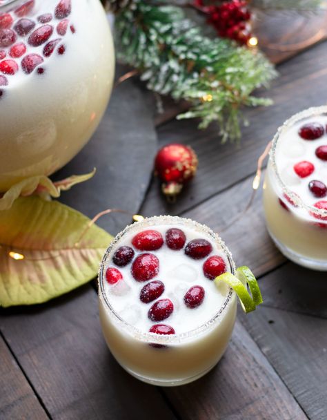 This Holiday Coconut Margarita Pitcher is perfect for entertaining guests throughout the winter. Fresh cranberries and a sugared rim complete this margarita with tequila, white cranberry juice, Malibu, fresh lime juice, orange juice and coconut milk. This Holiday Coconut Margarita Pitcher is perfect for entertaining guests throughout the winter. Fresh cranberries and a sugared rim Cranberry Coconut Margarita, Coconut Cranberry Margarita, Coconut Margarita Pitcher, Holiday Margaritas Pitcher, Winter Margarita Recipe, Pitcher Cocktails Winter, Holiday Pitcher Cocktails, Christmas Coconut Margarita, Christmas Margarita Pitcher