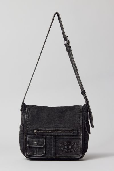 Essential messenger bag crafted from premium BDG denim. Low-profile silhouette with a pocketed flap closure. Lined interior with two pockets and plenty of space for your essentials. Complete with a zip pocket at the back for easy access, plus a water bottle pocket at the side. Finished with an adjustable strap wear it on your shoulder or crossbody. Urban Outfitters exclusive. Features. BDG denim messenger bag Washed soft denim with tons of storage Plenty of pockets inside and out Water bottle po Side Bags For Men Mens Fashion, Side Bag For Man, Man Bags Shoulder For Men, Urban Mens Fashion Streetwear, Downtown Boy, Cowboy Outfit For Men, Denim Messenger Bag, Messager Bag, Men Handbag