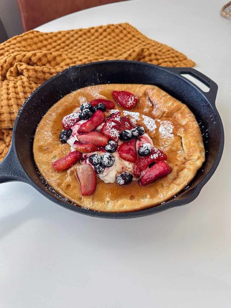 Have you ever had a Dutch baby Pancake before? This soft, custardy, yet fluffy delight, also known as a German pancake, is cooked to perfection in a cast iron skillet. It’s an incredibly easy recipe, and the batter comes together in just a blender. This high protein Dutch baby is the ultimate healthy indulgence, perfect for breakfast or brunch. High Protein German Pancake, Protein Dutch Baby, High Protein Yogurt, German Pancakes, Protein Yogurt, Dutch Baby Pancake, Sugar Free Syrup, Dutch Baby, Protein Recipes