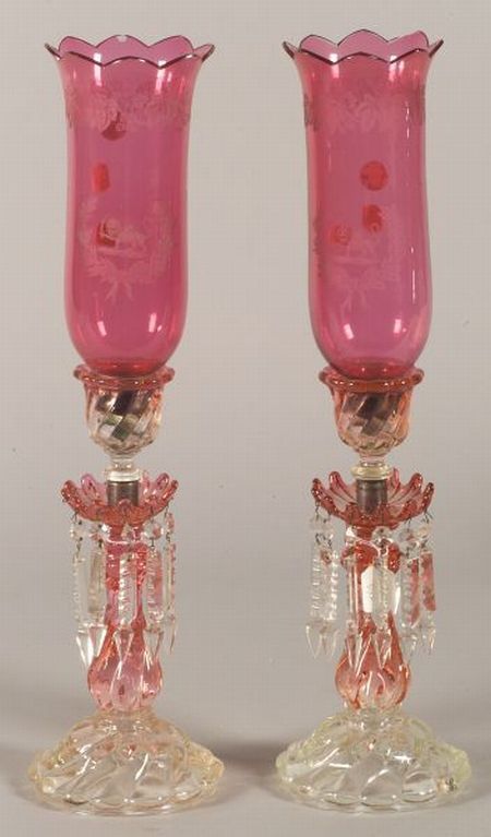 Pair of Molded Colorless and Cranberry Glass Single Light Mantel Lustres, late 19th century, with vertically ribbed molded bell-form nozzle on baluster stem and domed foot, the body graduating in color from cranberry to near clear, hung with colorless molded glass drops, with associated faux-etched cranberry glass hurricanes, body ht. 12 5/8, ht. with hurricane 22 in. Cranberry Glassware, Pretty Glassware, Antique Mantel, Unique Glassware, Victorian Lamps, Beautiful China, Old Lamps, Side Table Lamps, Cranberry Glass