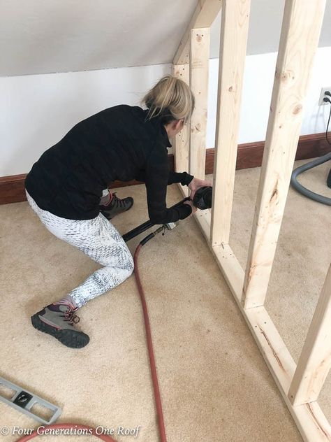 Jessica Bruno nailing 2x4's every 16" on center to create a closet wall Low Slanted Ceiling, Wall Closet Bedroom, Slanted Wall Closet, Knee Wall Closet, Framing A Closet, Slanted Ceiling Closet, Sloped Ceiling Closet, Attic Bedroom Closets, Loft Closet