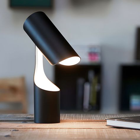 The Black Table Lamp is a model of minimalist design. Its black finish gives it a modern look, and the glossy white interior revealed when the lampshade is lifted adds an interesting contrast of color and texture. The lamp stands freely, its columnar shape demonstrating the harmony of geometry and utility. A switch on the cord allows for easy operation.   This desk lamp is 8.7'' Diameter wide, 13.4'' Height, and weighs only 4.41lb.The base and body, both cylindrical, ensure stability and present Black Desk Lamp, Metal Desk, Steel Lighting, Table Led, Metal Desks, Small Table Lamp, Black Desk, Black Table Lamps, Form Design