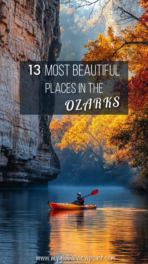 A lone kayaker paddles through a serene river flanked by towering cliffs and vibrant fall foliage in the Ozarks, capturing the region’s natural beauty and some of the most beautiful places in the Ozarks. Ozarks Vacation, Travel Missouri, Lake Of The Ozarks Missouri, Ozarks Missouri, Lake Of The Ozarks, Ozark Mountains, The Ozarks, Summer Trip, Inspo Board