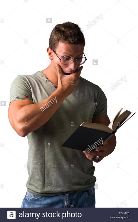 Muscular young man standing reading book with surprised expression, isolated on white Stock Photo Standing With Book Pose, Man Action Pose Reference, Person Thinking Reference, Man Holding Book Pose Reference, Person With Book Reference, Person Reading Book Reference, Reading Book Pose Reference, Surprised Reference, Surprise Reference