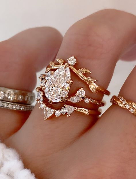 Harmony is a whimsical rose gold engagement ring that embodies the perfect balance of nature-inspired elegance and vintage charm. Our Adelixa acts as her leafy crown with a pop of sparkle. Kya completes this stack with her collection of trillion and round cut diamonds, and a dainty leaf engraving sits on either side to tie in an element of nature. Drop-down diamond options represent our recommended grade, which maximizes size for value, while maintaining eye-perfect clarity and giving you a colo