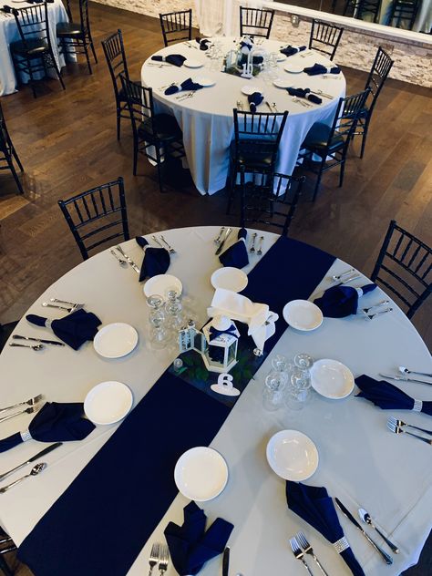 Simple yet elegant wedding reception decor. Navy napkins with rhinestone napkin holder. Centerpieces are white lanterns with navy and silver accents. Central Florida wedding planners. Wedding Decorations Navy Blue, Navy Blue And Silver Wedding, Navy Wedding Decorations, Silver Wedding Reception, Silver Wedding Centerpieces, Blue And Silver Wedding, Navy Blue Wedding Theme, Silver Wedding Theme, Blue Silver Weddings