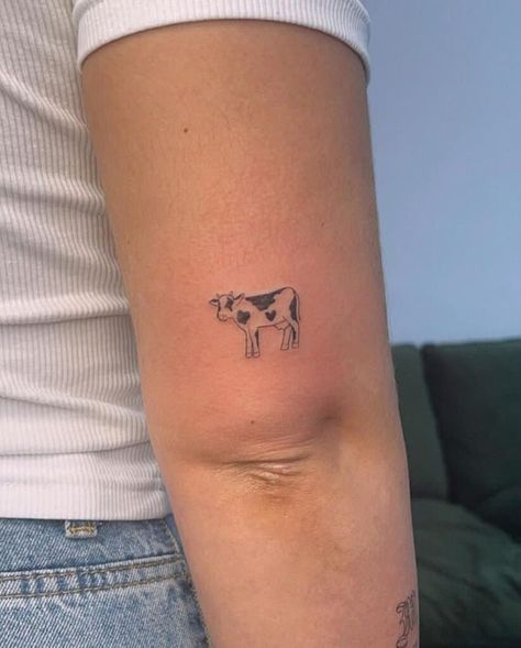 15. A small and simple cow tattoo Patchwork, Small Tattoo Body Placement, Cow Silhouette Tattoo, Dairy Cow Tattoo Ideas, Funny Cow Tattoo, Minimal Cow Tattoo, Highland Cow Outline Tattoo, Cow Line Tattoo, Dainty Cow Tattoo