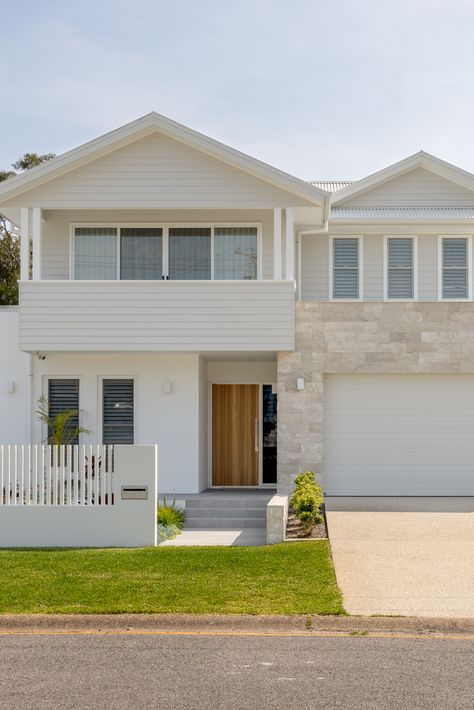 The Corlette House has been designed to fit comfortably within the surrounding context and is located within the popular holiday area of Port Stephens. The original house on the site was the families holiday home. The clients were retiring, and the brief was to create their forever home that could still accommodate their family on holidays. Weatherboard House Facade, Beach House Cladding, Beach House Contemporary, Fibro House Exterior, House Renovation Ideas Exterior, Exterior House Colors Australian, Stone Garage, Beach House Facade, Exterior Facade Design