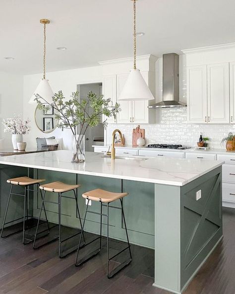 a white farmhouse kitchen with shaker style cabinets, an olive green kitchen island, white stone countertops and white pendant lamps Contrasting Kitchen, Contrasting Kitchen Island, Green Kitchen Island, White Shaker Kitchen Cabinets, White Shaker Kitchen, Green Island, Kitchen Island Ideas, Green Kitchen Cabinets, White Kitchen Decor