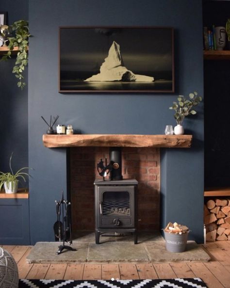 With a modern sensibility, some smart editing, and a hint of rustic blue, you can create a space that feels alive with color and rich in history at the same time. Here's how. #hunkerhome #blue #blueinterior #bluepaint #bluewalls Blue Living Room Ideas, Dark Wood Living Room, Log Burner Living Room, Blue Walls Living Room, Dark Blue Living Room, Navy Living Rooms, Navy Blue Living Room, Snug Room, Dark Living Rooms