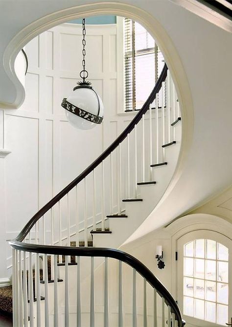 Cottage home features a winding staircase lined with board and batten walls illuminated by a black and white globe lantern. Batten Staircase, Staircase Wall Design, Wood Stair Treads, White Staircase, Traditional Staircase, Winding Staircase, Board And Batten Wall, Staircase Wall, Staircase Makeover