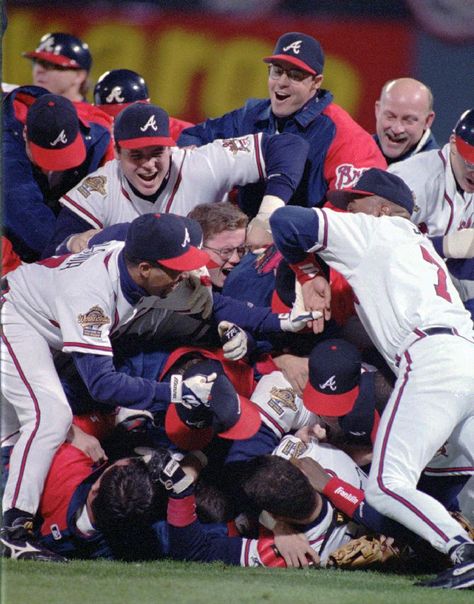 In this Oct. 28, 1995, file photo, the Atlanta Braves celebrate their 1995 World Series win against the Cleveland Indiants at Atlanta Fulton County Stadium in Atlanta. After a one-year delay caused by the 7 and a half-month players' strike, the expanded playoffs began in 1995, when teams played a 144-game schedule because of the walkout. The top teams met that October, with Atlanta defeating Cleveland in six games. (AP Photo/Andrew Innerarity, File) Atlanta Braves Wallpaper, Georgia Peaches, Baseball Pitching, Atlanta Braves Baseball, Baseball Teams, Chop Chop, Braves Baseball, Baseball Photos, Minor League Baseball