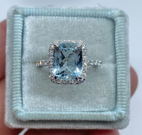 Beautiful Aquamarine and Diamond Ring set in 14K White Gold. The aquamarine is surrounded by a halo of sparkling diamonds, the sides are open allowing a lot of light and sparkles. The under halo of diamonds gives a nice sparkle from the side profile. The aquamarine is a nice size stone. The halo measures 12.2 x 10.5mm. Genuine cushion cut Aquamarine 10x8mm 2.93 Carats Clarity: VS Eye Clean stone Halo measures: 13.3 x 11 mm Genuine Round brilliant cut diamonds total weight: 0.69 Carats Clarity: S Aquamarine Engagement Ring White Gold, خواتم خطوبة, Cute Engagement Rings, Future Engagement Rings, Aquamarine Engagement Ring, Engagement Ring White Gold, Girly Accessories, Ring White Gold, Dream Engagement Rings