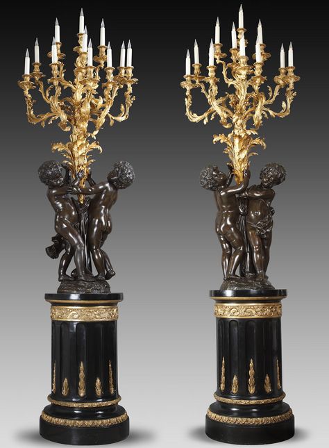 Pair of “Putti” torcheres attributed to bronze-caster V. Paillard, France, circa 1870 A pair of two patina bronze torcheres. Each modelled as a pair of putti holding aloft a large foliate shaft issuing eleven berried-acanthus scrolled branches terminating in conforming drip-pans and nozzles, on a circular parcel-gilt and ebonised plinth with fluted shaft. Rococo Lighting, Marble Fireplace Surround, French Interiors, Antique Fireplace, Art Nouveau Design, French Furniture, Bronze Statue, Lantern Candle Holders, How To Antique Wood