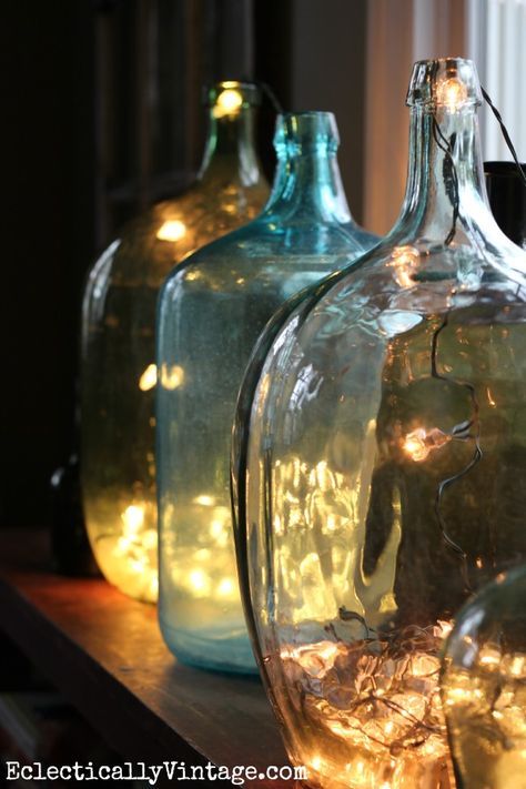 Demijohn bottles filled with string lights for Christmas kellyelko.com Christmas Lights Inside, Christmas House Tour, Deco Nature, Glass Jug, Vintage Bottles, Coastal Christmas, Christmas House, Bottles And Jars, Holiday Lights