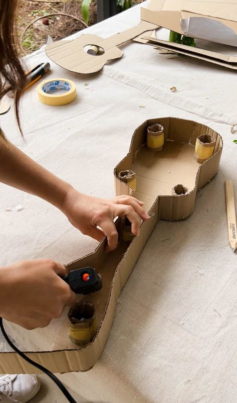 A Pair & A Spare | Making a Kids Cardboard Guitar How To Make Guitar With Cardboard, How To Make A Guitar Out Of Cardboard, Cardboard Guitar Diy, Kids Guitar Craft, Dramatic Play Diy, Guitar Craft, Cardboard Guitar, Cardboard Camera, Diy Crafts For Boyfriend