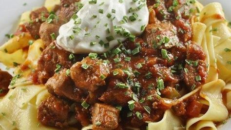 This recipe for Hungarian stew made with pork loin and bacon is seasoned with paprika and served over egg noodles. Recipe With Egg Noodles, Hungarian Goulash, Goulash Recipe, Paprika Pork, Carlsbad Cravings, Pork Stew, Goulash Recipes, Hungarian Recipes, Tender Beef