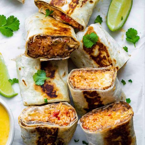 Cheesy Bean and Rice Burritos Recipe Cheesy Bean And Rice Burrito, Bean And Rice Burrito, Rice And Bean Burrito, Easy Burrito Recipe, Burrito Ingredients, Rice Burrito, Bean And Rice, Mexican Rice Recipes, Burrito Recipe