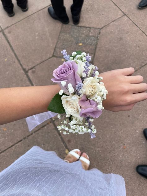 Lavender corsage with white ribbon, baby’s breath, lavender roses, white spray roses and faux lavender sprigs. Purple And White Prom Flowers, Light Purple Wrist Corsage, Purple And White Corsage And Boutonniere, Purple Wedding Corsage, Corsages For Prom Purple, Light Purple And White Corsage, Corsage Prom Light Purple, Wedding Flowers Purple And White, Lavender Prom Corsage