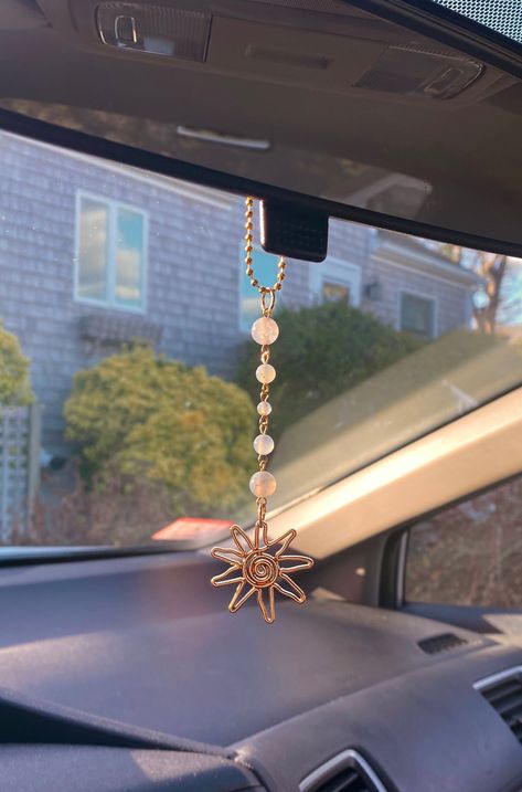 NOTE: Each bead is unique and one of a kind, and there may be slight discrepancies in shape/hue between the product shown and the product received. Chain Length: ~3" Charm Length: ~4" Total Length: 6.5-7" The Sun Handmade Car Charm is a 100% unique addition to your rearview mirror. Inspired by boho and nature-y aesthetics, this cute accessory brings the beauty of the summer sun straight to your car's interior. Crafted with high quality materials including real agate crystal beads (clear), real m Crystal Car Charms, Rearview Mirror Decoration, Girly Car Accessories, Gold Car, Car Deco, Rear View Mirror Decor, Girly Car, Pearl Gifts, Cute Car Accessories