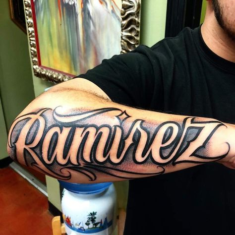 Last Names Tattoos On Arm, Shading Around Name Tattoo, Letters For Tattoos Fonts, Chavez Tattoo Name, Tattoo Names On Arm, Last Name Arm Tattoo, Sanchez Tattoo Last Name, Negative Shading Tattoo Letters, Last Name Tattoos For Men On Back