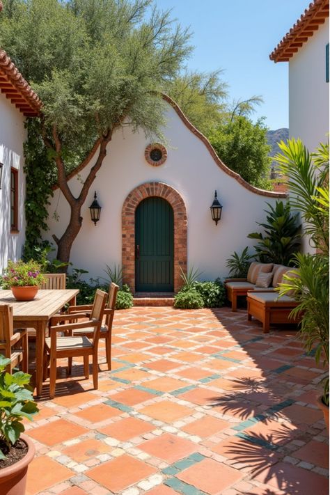 Mediterranean backyard patio with terracotta tiles, white walls, and mosaic accents Spanish Tile Patio Outdoor Areas, Tile Porch Ideas, Terracotta Outdoor Tiles, Spanish Patio Ideas, Terracotta Pavers, Mediterranean Outdoor Patio, Terracotta Tiles Outdoor, Patio Materials, Mediterranean Patio Ideas