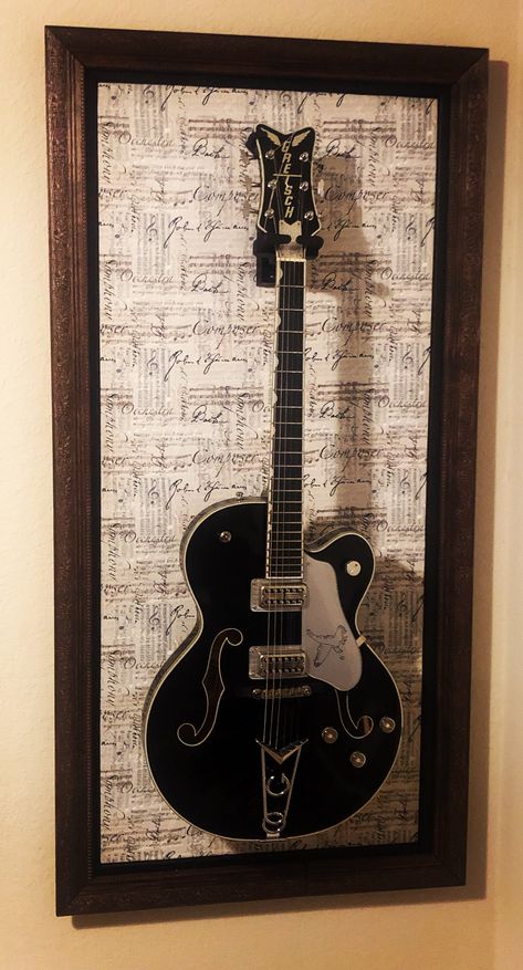 Guitar Placement In Bedroom, Tv And Guitar Wall, Guitar Wall Living Room, Guitar Wall Display Ideas, Hang Guitar On Wall Ideas, Guitar Mounted On Wall Decor, Guitar Hanging Ideas Bedroom, Guitar Frame Display, Guitar Themed Bedroom