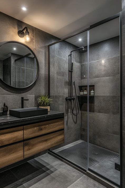 Discover modern bathroom ideas with this sleek design featuring a glass shower enclosure, dark tiles, and contemporary fixtures. The mix of wood and black elements creates a stylish and functional space that’s perfect for relaxation. #ModernBathroomIdeas #HomeDesign #BathroomInspo Modern Brown Bathroom Ideas, Rustic Industrial Bathroom Design, Small Bathroom Looks, Black Bathtub Bathroom Ideas, Dark Ensuite Bathroom Ideas, Family Bathroom Ideas Modern, Modern Moody Bathroom, Small Bathroom Ideas Dark, Dark Spa Bathroom