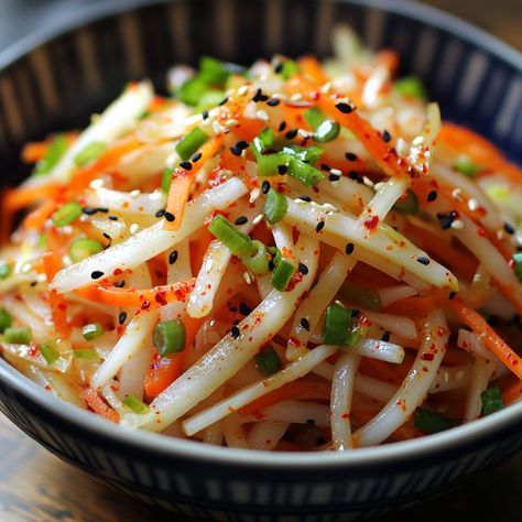 🥕 "Fresh, crisp, and zesty—this Korean Radish Salad is a must-try for your next meal!" 🥕 #KoreanSalads #FreshAndZesty Korean Radish Salad Ingredients: Korean radish (1 medium, peeled and julienned) Carrot (1 medium, julienned) Green onion (2, chopped) Red pepper flakes (1 tsp) Rice vinegar (2 tbsp) Sugar (1 tbsp) Soy sauce (1 tbsp) Sesame oil (1 tsp) Salt (½ tsp) Instructions: In a bowl, mix radish, carrot, and green onion. Combine red pepper flakes, rice vinegar, sugar, soy sauce, sesame... Chinese Carrots, Korean Radish, Carrots Side Dish, Daikon Radish, Julienned Carrots, Radish Recipes, Instagram Recipes, Radish Salad, Foreign Food