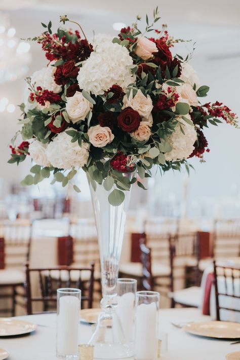 Burgundy Tall Centerpieces, Marsala Wedding Theme, Burgundy Wedding Table Set Up, Wine Colored Wedding Flowers, New Year’s Eve Colors, Champagne And Burgundy Wedding Flowers, Big Flower Centerpieces Wedding, Wedding Flowers Wine Color, Wedding Centerpieces Maroon