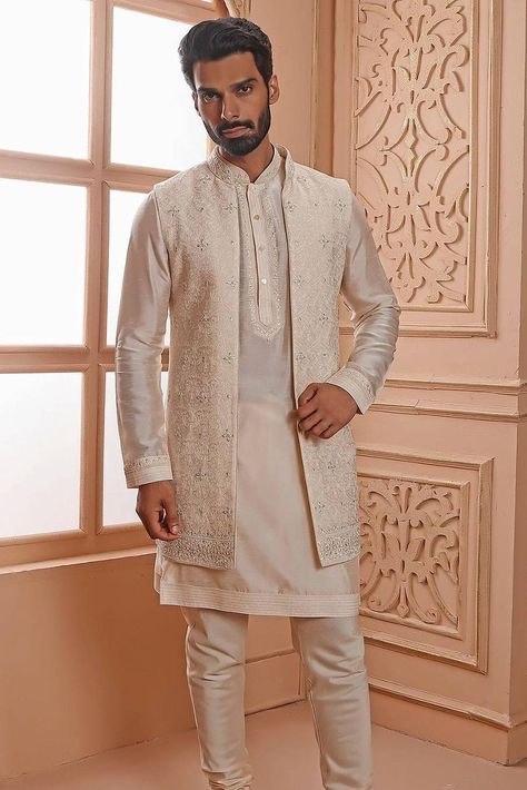 Whether you are planning to attend a friend’s Mehndi or going to a Sangeet ceremony, a kurta with jacket for men is more versatile than your usual run-of-the-mill options. Here's how! Men Kurta With Jacket, Kurta With Long Jacket For Men, Jacket Kurta For Men, Kurta With Jacket For Men, Long Jacket For Men, Long Jacket Outfit, Kurta With Jacket, Groom Clothes, Grooms And Groomsmen