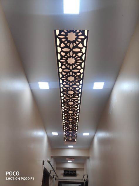 Gypsum false ceiling for small passage with mdf jali design Mdf False Ceiling Design, Lobby Fall Ceiling Design, Small Passage Ceiling Design, Passage Fall Ceiling Designs, Entrance Pop Design, Jali Design For Ceiling, L Shape Pop Ceiling Design, Duplex False Ceiling Design, Lobby Ceiling Design Entrance