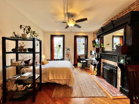 Studio apartment in Brooklyn with huge ornate glossy black wood fireplace surround. Ikea Hacks For Cats, My Studio Apartment, Wood Fireplace Surrounds, Toy Storage Bench, Black Fireplace, Tiny Studio, Doll Beds, Black Fire, New York Style