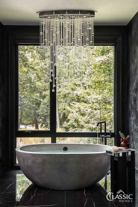 An elegant bath with freestanding tub, black tile and black textured walls, with a modern chandelier over the tub. Bath In Bedroom Free Standing, Bathroom Stand Alone Tub, Stand Alone Bath Tub, Bathroom Vibes, Stand Alone Bathtubs, Onsen Bath, Master Bath Design, Standing Tub, Modern Tub