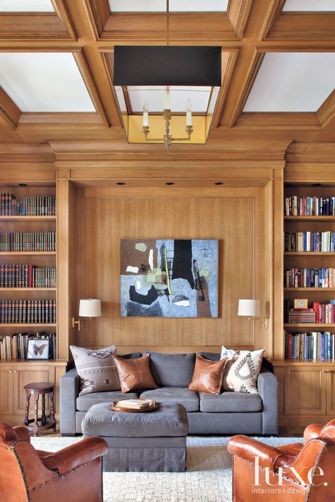 The rear façade shows off the exterior’s classic East Coast vibe. A covered terrace houses a teak dining table and chairs from Adams Furniture in High Point, North Carolina, and Kingsley-Bate head chairs. Custom bifolding Marvin doors from Goldfinch Brothers open to connect the indoors and outdoors. Transitional Library, Cozy Library, Oak Panels, Teak Dining Table, Rustic Contemporary, Luxe Interiors, Interior Design Magazine, Interiors Design, Home Library